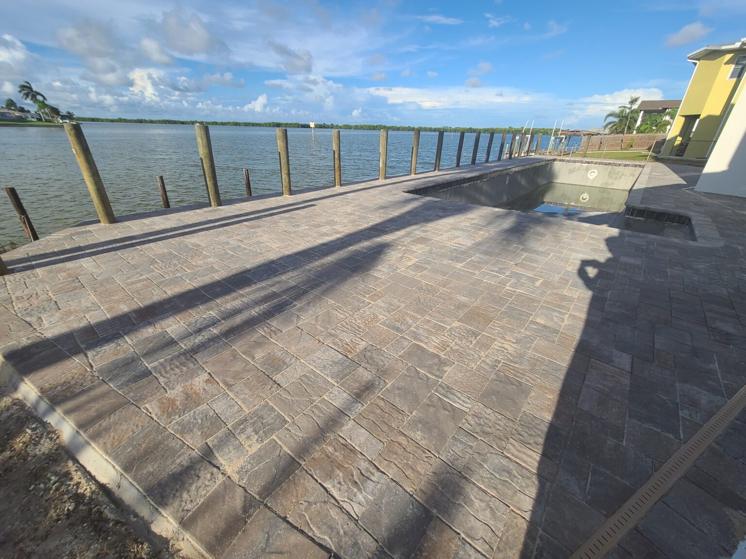 Waterfront paver patio along a seawall in Brevard County